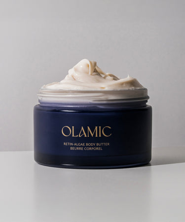 Jar of OLAMIC Retin-Algae Body Butter with rich cream overflowing