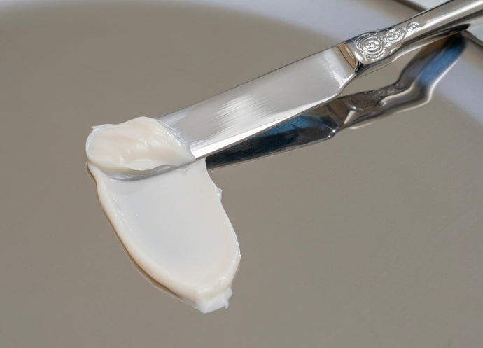 Luxury body butter formula from OLAMIC displayed in a creamy swipe